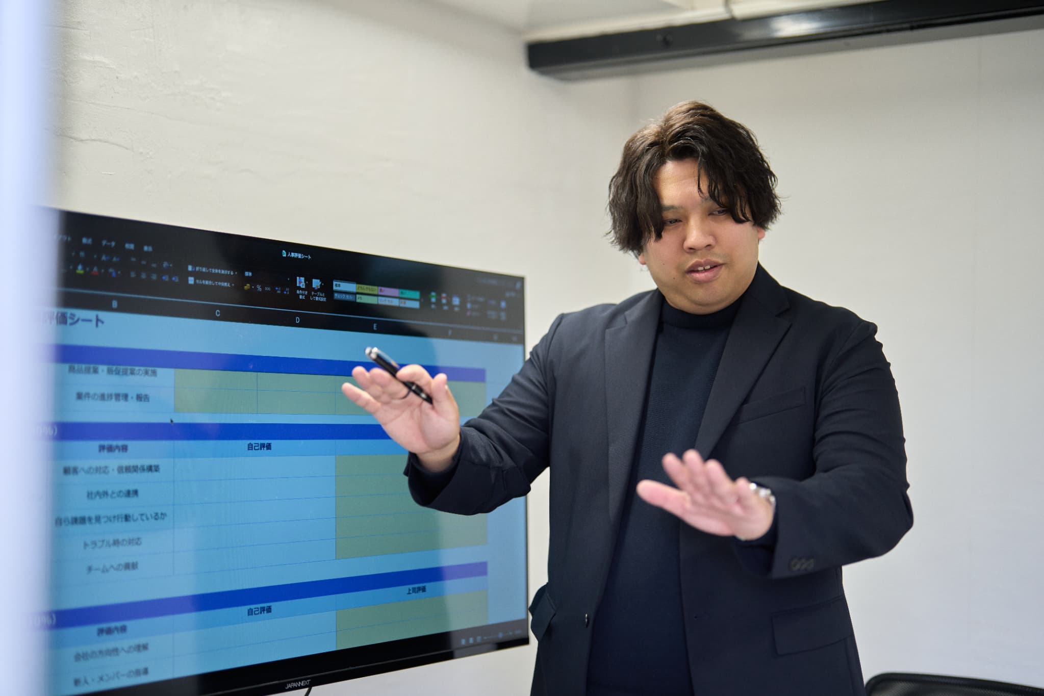 資料を見て打ち合わせる6人の会社員